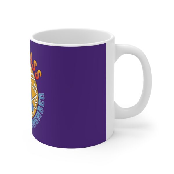 A purple mug with the hogwarts crest on it.
